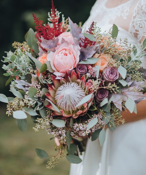 The,Bride,In,A,White,Dress,Is,Standing,And,Holding